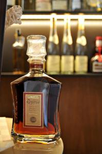 une bouteille de whisky assise sur une table avec des bouteilles d'alcool dans l'établissement Hotel Restaurant Bürgerklause Tapken, à Garrel