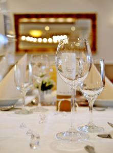 a group of wine glasses sitting on a table at Hotel Restaurant Bürgerklause Tapken in Garrel