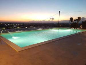a swimming pool with a sunset in the background at Hotel Ristorante Paradiso in Albanella