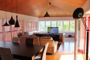 a living room with a couch and a piano at Casa da Bichaca in Castelo de Paiva