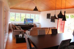 a living room with a table and chairs and a piano at Casa da Bichaca in Castelo de Paiva