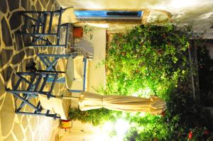 an umbrella is attached to a building with flowers at Margarita Hotel in Kythira