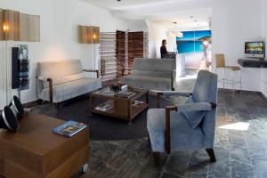a living room with two chairs and a table at Hotel Boutique Ses Pitreras in San Antonio Bay