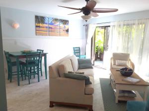 a living room with a couch and a table at Maui Tranquility in Kihei