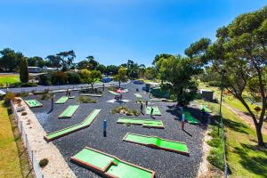 a green park filled with lots of landscaping at BIG4 Naracoorte Holiday Park in Naracoorte