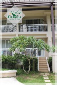 a building with a staircase and palm trees in front of it at CAROLA in Pico de Loro in Nasugbu