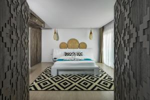 a bedroom with a bed and a rug at Villa Sonata Phuket in Chalong +33 photos