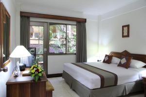 a hotel room with a bed and a window at The Jayakarta Bali Beach Resort in Legian
