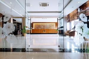 a lobby with glass doors and a reception desk at Nagoya Mansion Hotel and Residence in Nagoya
