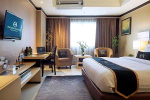 a hotel room with a large bed and a desk at Nagoya Mansion Hotel and Residence in Nagoya