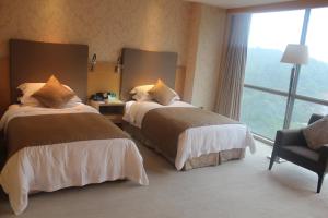 Ein Bett oder Betten in einem Zimmer der Unterkunft Wudang International Hotel