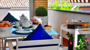 a table with a blue table cloth on a patio at B&B La Casa di Giò in Casal Palocco