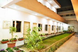 a courtyard of a building with plants at Hotel Palace in Amritsar