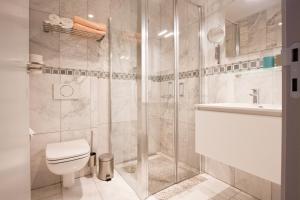 a bathroom with a shower and a toilet and a sink at Shangrilaherzele in Herzele