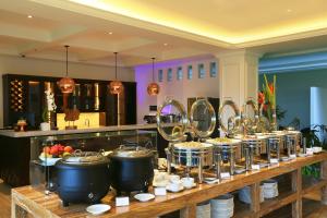a buffet line with pots and pans of food at Grand Palace Hotel Sanur - Bali in Sanur