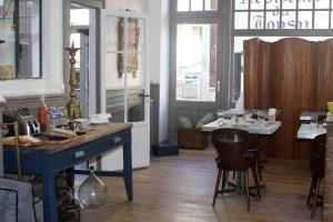 a kitchen with a table and chairs in a room at La Maison de la Plage in Trouville-sur-Mer