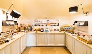 a kitchen with white cabinets and a counter top at The Heidelberg Exzellenz Hotel in Heidelberg