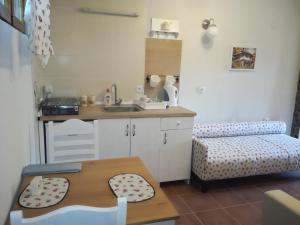 a small kitchen with a sink and a table at Seosko turističko domacinstvo Imunsan in Niš +177 photos