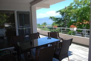 a table and chairs on a balcony with a view at Madzar Apartments in Star Dojran