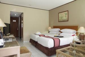 Voodi või voodid majutusasutuse The Jayakarta Yogyakarta Hotel & Spa toas