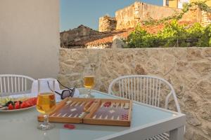 a table with a book and two glasses of wine at Aenaon Seaview Villa in Plataniás