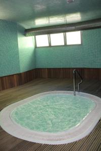 a large tub in a room with a water fountain at Golden Residence Hotel in Funchal