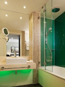 a bathroom with a sink and a shower at Holiday Inn London - Whitechapel, an IHG Hotel in London