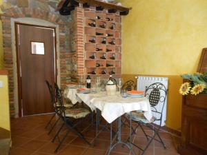 a dining room with a table and chairs and a wine cellar at B&B La Corte in Capannori