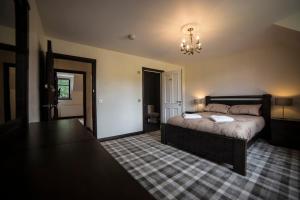 a bedroom with a bed and a chandelier at Whitehouse B&B in Fort Augustus