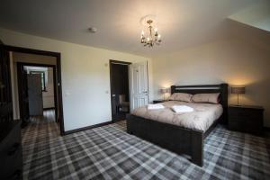 
a bedroom with a bed and a dresser at Whitehouse B&B in Fort Augustus
