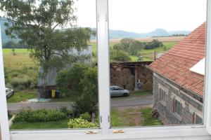 an open window with a view of a street at BIO-Bauernhof Rhön in Schleid