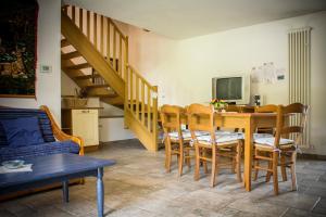 a living room with a dining room table with chairs at Albergo Diffuso Zoncolan in Ovaro