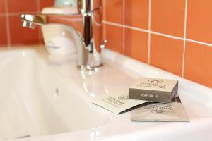 a box of soap sitting on top of a bathroom sink at Albergo Diffuso Zoncolan in Ovaro +113 photos