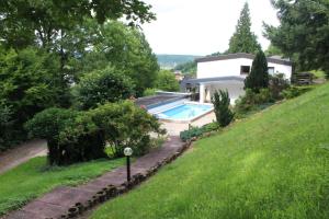 a house with a swimming pool in a yard at Haus am Wald in Eltmann