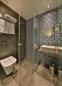 a bathroom with a toilet a sink and a shower at Alilass Hotel in Istanbul