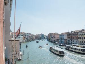 a view of a canal with boats in the water at Luxury Apartment On Grand Canal by Wonderful Italy in Venice