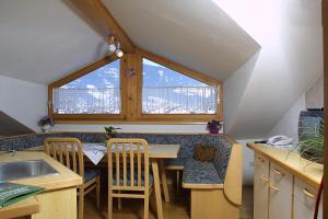 a kitchen with a table and chairs and a window at Haus Vital, Rottmann in Altenmarkt im Pongau