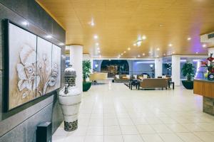 a lobby with tables and chairs in a building at Grand Muthu Forte do Vale in Albufeira