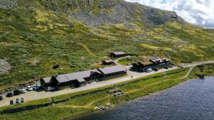 an aerial view of a house on an island in the water at Smuksjøseter Fjellstue in Høvringen