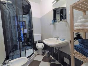 a bathroom with a toilet and a sink and a shower at Apartments Pegla in Nerezine +33 photos