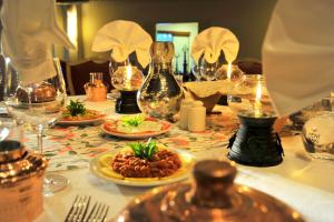 a table topped with plates of food and wine glasses at Martı Myra - Ultra All Inclusive in Tekirova