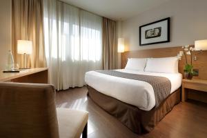 a hotel room with a large bed and a large window at Eurostars Lucentum in Alicante