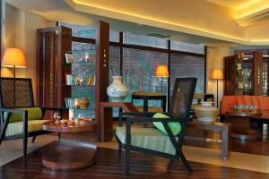 a living room with chairs and tables and a window at Martı Myra - Ultra All Inclusive in Tekirova