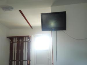 a flat screen tv hanging on a wall at Hotel Vivat in Velikodolinskoye