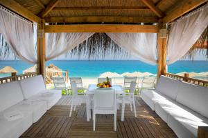 a restaurant with a table and chairs on the beach at Martı Myra - Ultra All Inclusive in Tekirova