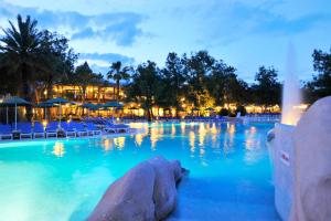 a pool at a resort at night at Martı Myra - Ultra All Inclusive in Tekirova