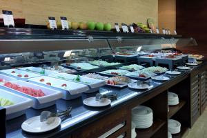 a kitchen filled with lots of different types of food at Eurostars Lucentum in Alicante