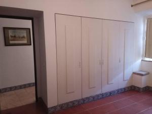 a room with white cabinets and a window at Casa da Lagoa Guest House in Évora +54 photos