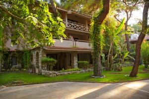 a house with a balcony and trees in front of it at Martı Myra - Ultra All Inclusive in Tekirova