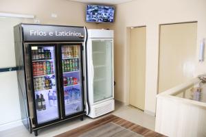 a refridgerator with a fridge with drinks in it at Hotel Vale das Artes in Embu